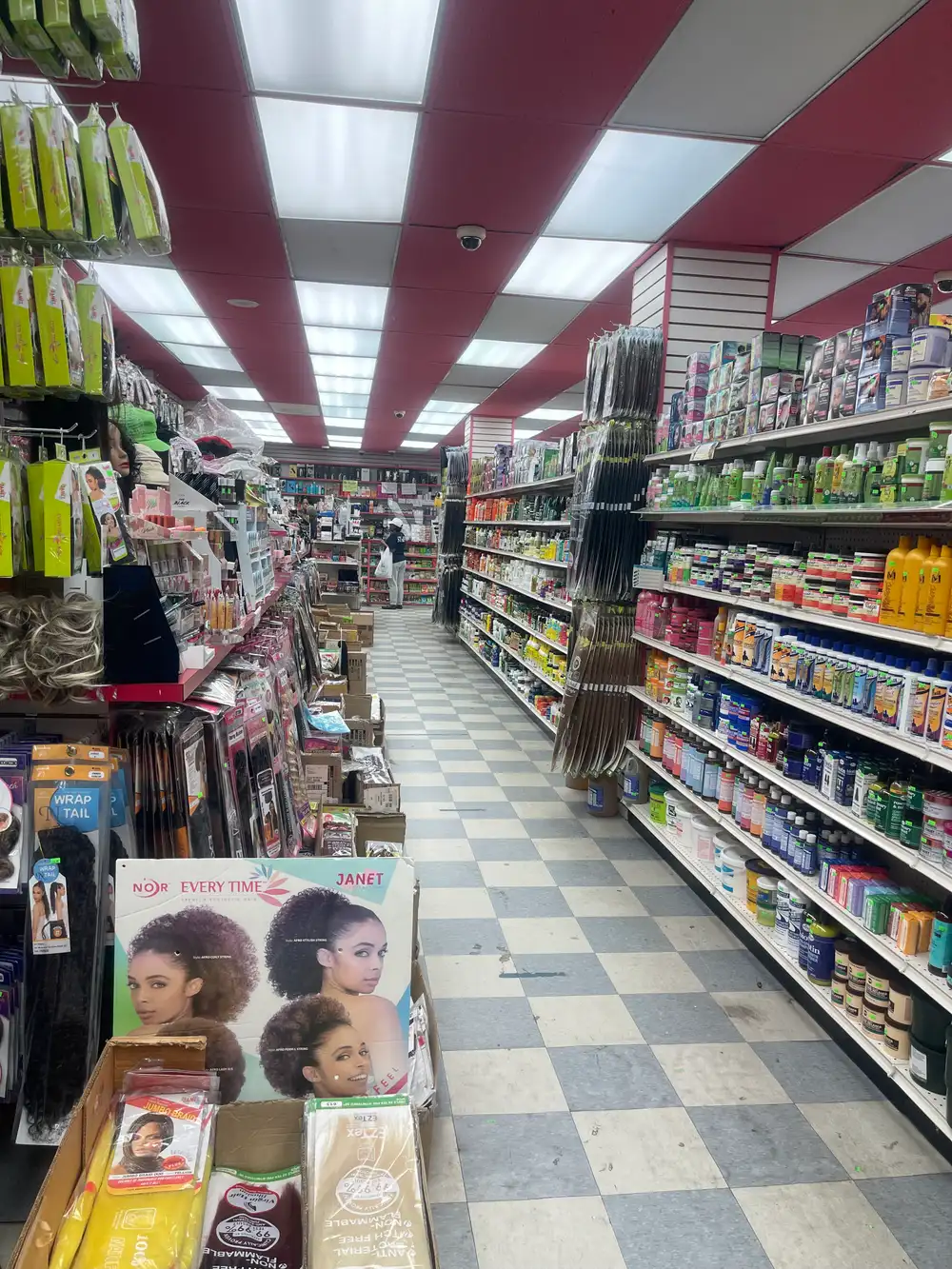 Wig and hair extension aisle inside Honey Beauty Supply in the Bronx